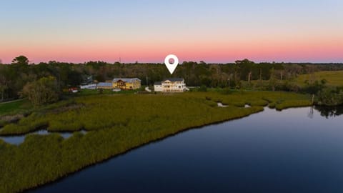 Waterfront home offering serene views of the marsh and tranquil sunsets. This secluded location provides privacy while being surrounded by nature's beauty, your perfect retreat!