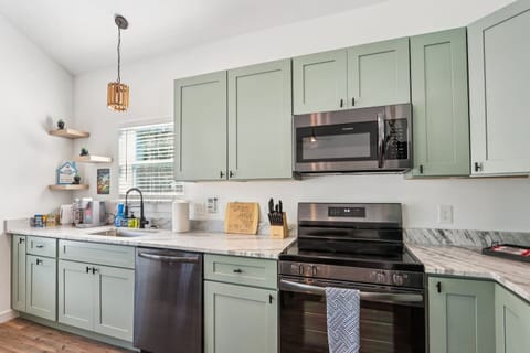 Full kitchen with refrigerator with water and ice dispenser, stove, oven, keurig with pods, hot water heater, toaster, pots/pans, baking sheets, cooking utensils, mixing bowls, plateware for 12, kids plateware, cups, wine glasses, coffee mugs, + more