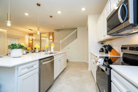 Enjoy the modern open kitchen with quartz countertops and stylish lighting-perfect for casual family gatherings and cooking together!