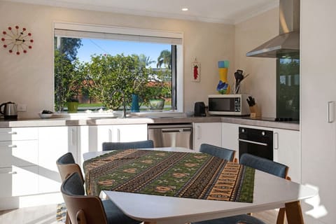 The kitchen has a microwave, dishwasher, oven, cooktop and fridge/freezer.