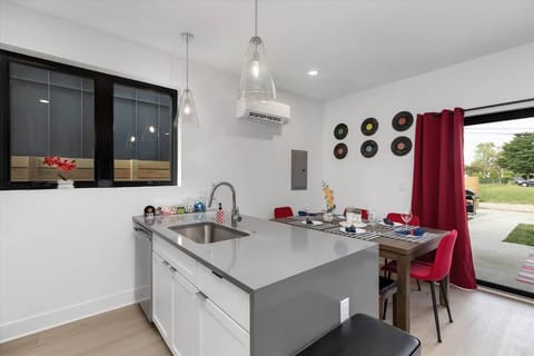 The kitchen island features a spacious countertop and built-in sink, perfect for cooking, prepping, and casual dining.