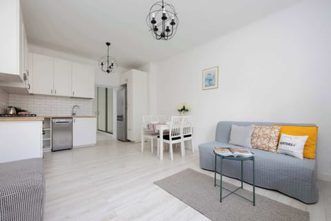 A bright, open space with a comfy sofa and dining area invites you to relax and enjoy meals together.