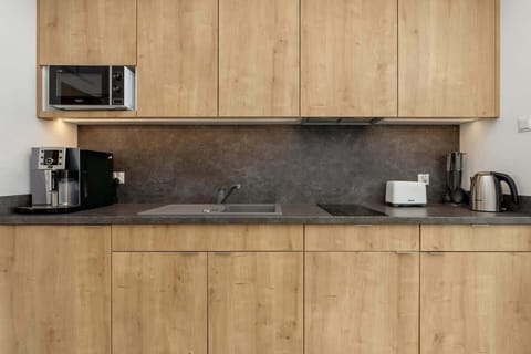 A detailed view of the kitchen workspace, showing a coffee machine and modern appliances. Everything you need within reach.