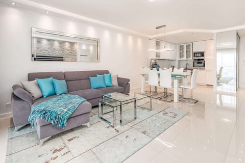 Living room combined with kitchenette. The decor of the room is bright and modern.