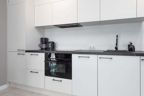 Kitchenette with plenty of kitchen utensils and dishes.