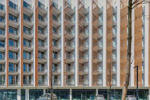 The exterior of a tall, modern apartment building with a unique grid-like design.