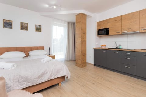Lounge area with double bed and kitchenette.