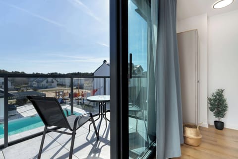 A modern glass balcony overlooking the garden will be a good place to enjoy the view.