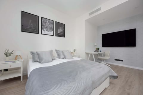 A bright interior with a comfortable bed and TV offers the perfect spot to unwind after a busy day.