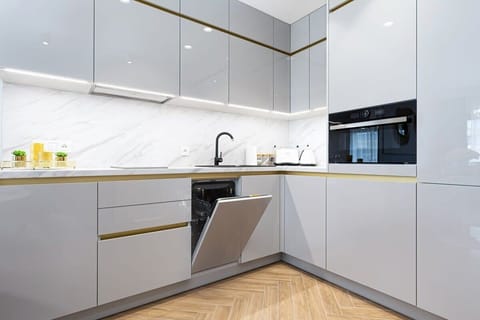 Kitchenette with oven and refrigerator. 