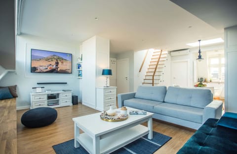 Living room with a comfortable sofa and TV. 