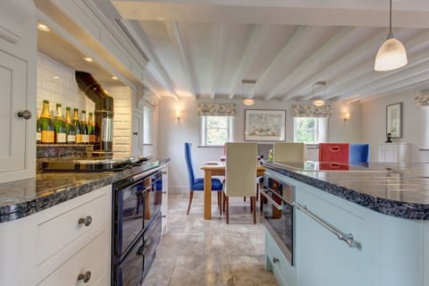 Ground floor: Kitchen/ dining area with electric range oven and induction hob (note; the Stanley oven has been disconnected), microwave, dishwasher, fridge-freezer and dining table with seating for eight