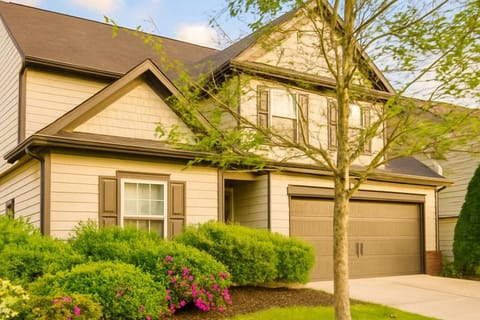 Charming home with lush greenery and vibrant blooms—your perfect getaway awaits!