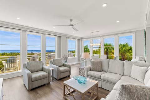 Sink into plush seating while soaking up stunning ocean views through floor-to-ceiling windows in your bright, airy living space.