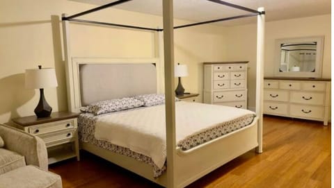 Elegant primary bedroom with poster king size bed