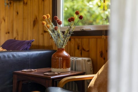 Flowers in a vase on a small table with seating either side
