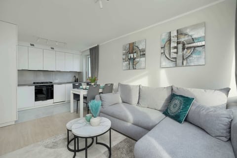 Open living space with sofa, TV, and dining table – Perfect for both entertainment and meals.
