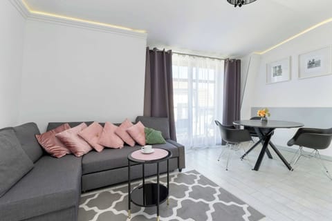 A cozy living room with a comfortable sofa, a coffee table, and elegant decor.