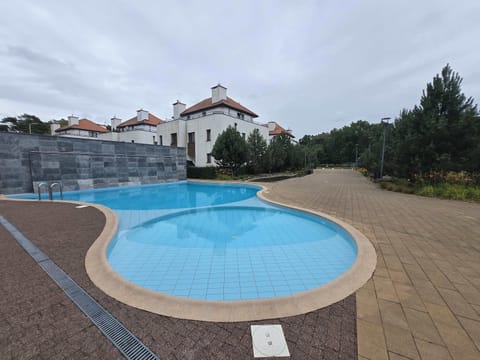 Take a break in the cozy outdoor pool – ideal for a quick swim or sunbathing nearby.