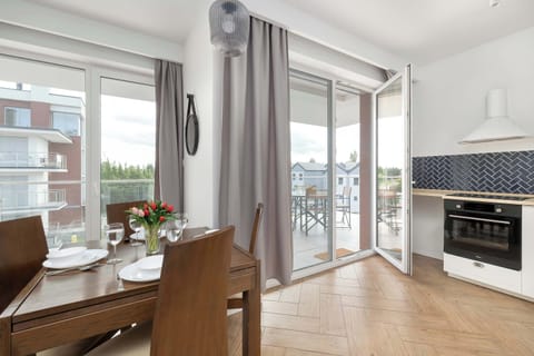 A dining living space with floor-to-ceiling windows and access to the balcony. Ideal for casual meals and morning coffee with natural light.