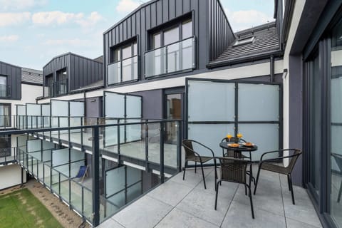 The glass-paneled balcony overlooking the inner patio is perfect for a peaceful morning coffee.
