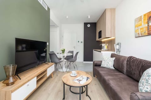 A modern entertainment unit with a large TV, sleek storage, and decorative accents in the living room.

