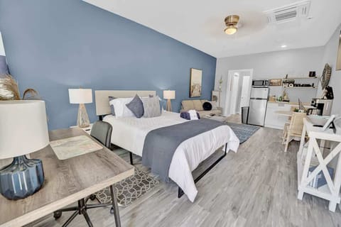 Entire room with a queen bed, seating area, kitchenette, dining area, smart TV, working space and a full bathroom! View from the entryway.
