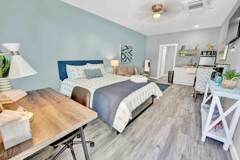 Entire room with a queen bed, seating area, kitchenette, dining area, smart TV, working space and a full bathroom! View from the entryway.