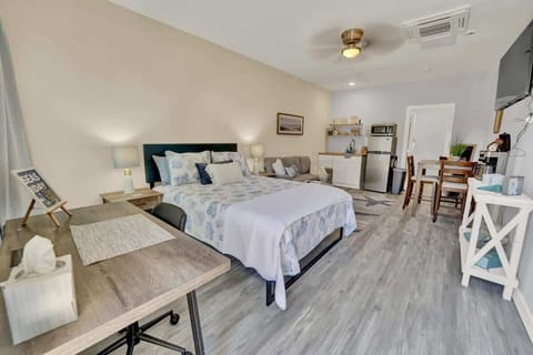 Entire room with a queen bed, seating area, kitchenette, dining area, smart TV, working space and a full bathroom! View from the entryway.