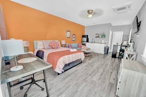 Entire room with a queen bed, seating area, kitchenette, dining area, smart TV, working space and a full bathroom! View from the entryway.