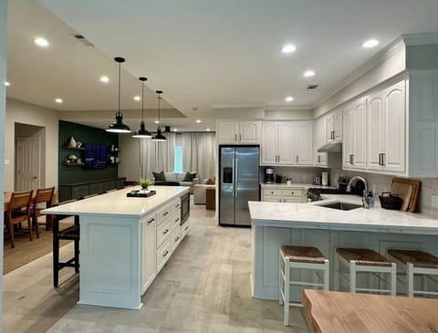 Step into comfort in this spacious home design. The open-concept layout seamlessly combines the large kitchen, dining area, and living room, making it the ideal space for families or groups to relax, cook, dine, and chat without missing a beat.