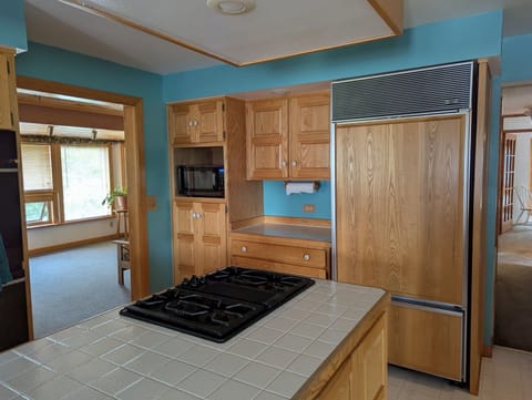 Spacious kitchen with island, double oven, propane stove, and microwave 