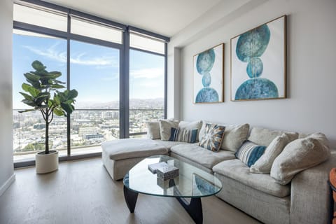The floor-to-ceiling windows in a living room offer panoramic cityscapes