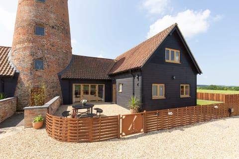 Fantail, Harpley: The front elevation of the house, showing the adjoining windmill