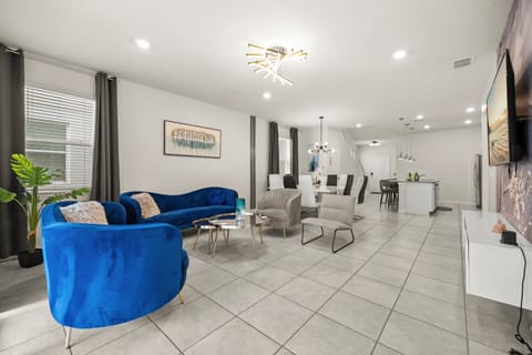 This open-concept living area is designed for comfort and connection, with plush seating and direct access to the private patio and pool.