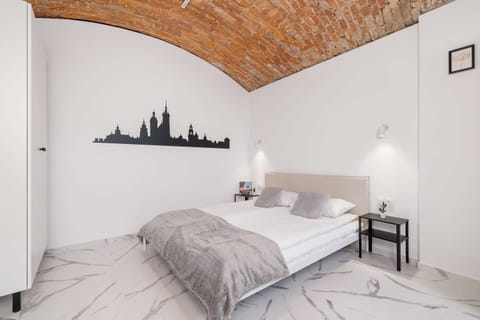 A cozy bed beneath the brick-vaulted ceiling creates a unique atmosphere perfect for relaxing.