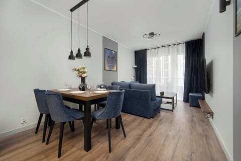 An elegant dining area with soft velvet chairs creates a perfect spot for long, shared meals.