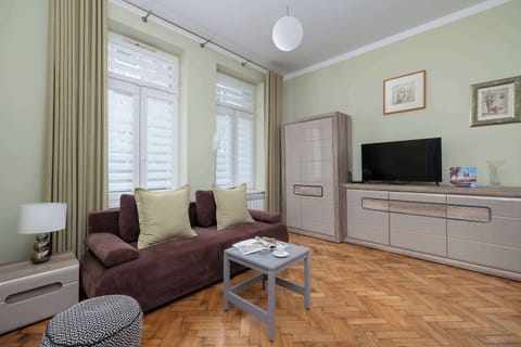 A living room with a corner sofa and TV stand.
Soft lighting and clean decor create a cozy, modern vibe.