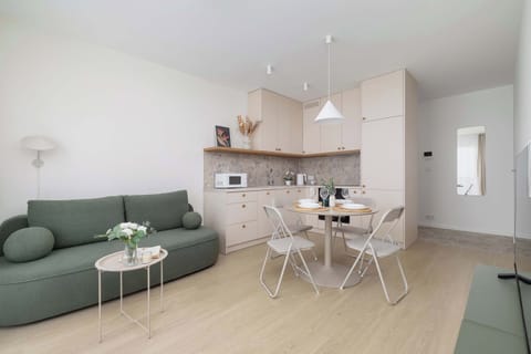 This cozy apartment is modernly decorated, with light-colored walls and wooden floors.