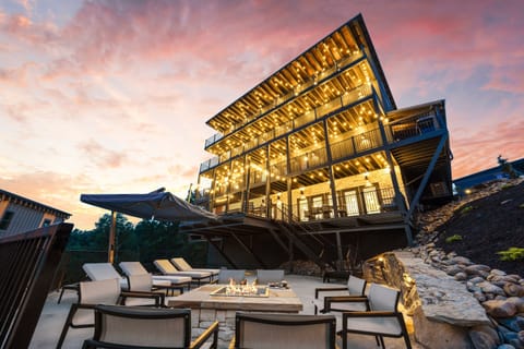 Unwind on the spacious deck with comfy loungers and warm string lighting. A perfect spot to relax, enjoy a drink, or gather with friends in a peaceful outdoor setting.