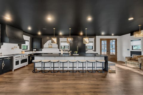 This fully equipped kitchen features high-end appliances and a large island perfect for cooking, serving, or gathering around for snacks and drinks.
