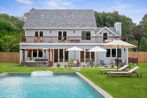 Back of the house showcasing the pool, large second floor deck & 1st floor patio