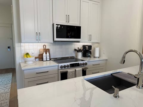 Well-stocked kitchen with tools, dishes, and trays for baking and cooking your favorite meals.