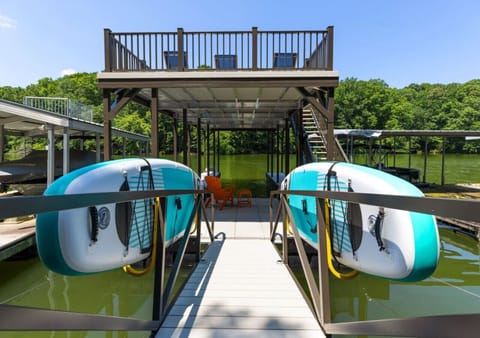 Your dock with 2 paddleboards, 2 kayaks, slip, and top deck for lounging and views