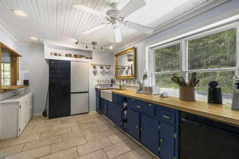 Spacious kitchen includes two side-by-side fridges and a freezer to feed a full house.