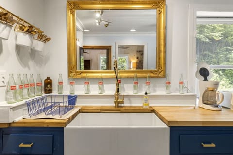 Kitchen includes large farmhouse sink.