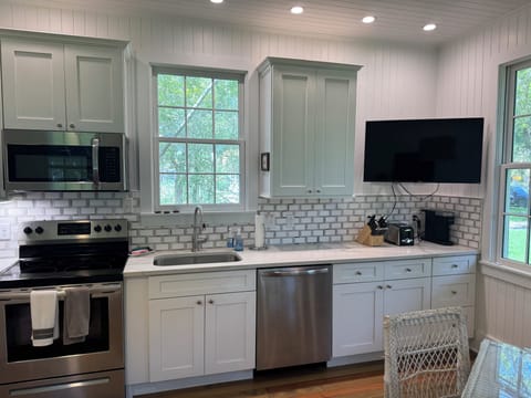 Fully stocked kitchen with all dishes, utensils, bakeware, and small appliances.