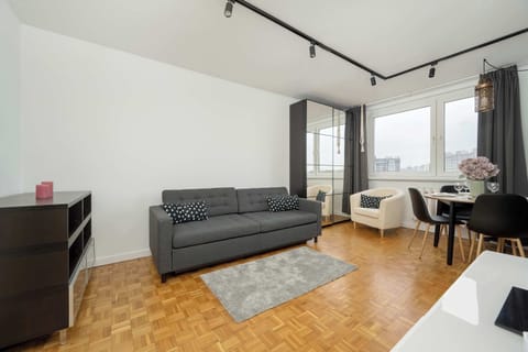 Traditional living room with dining area, double sofa bed, television, and armchair.