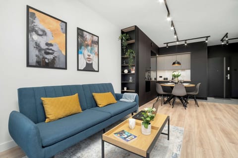 Modern, air-conditioned living room with a kitchenette and dining area.