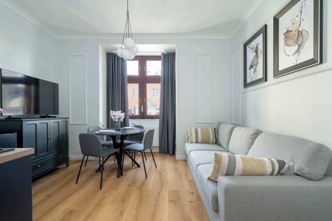 Stylish studio with a sofa bed, TV and dining area.
